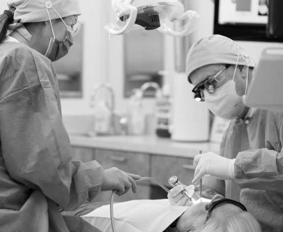 Dr. Coats and dental assistant working on patient